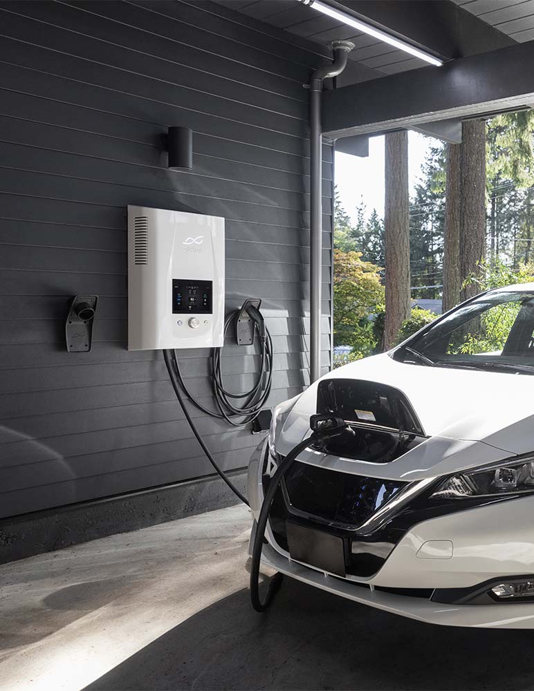 An electric car at home getting a charge from an EV charging station in the garage