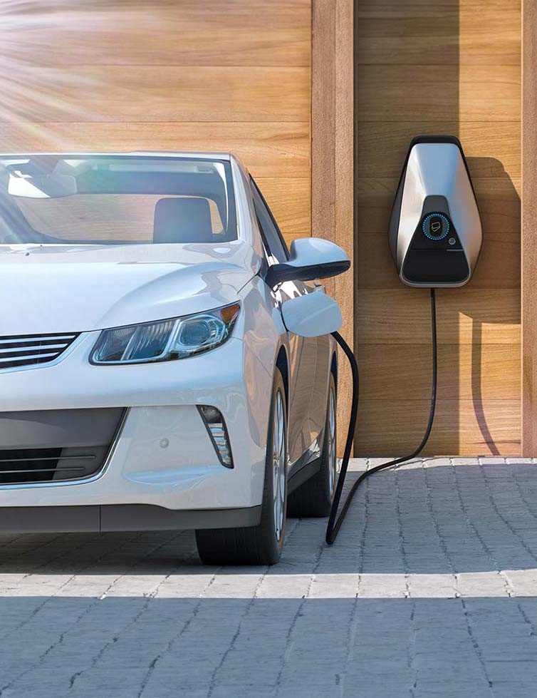 An electric car at home getting a charge from an EV charging station
