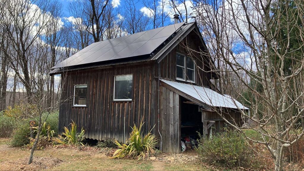 A small solar-powered cabin in Shelburne Falls, Massachusetts, showing how rural homes are using solar energy for year-round reliability.