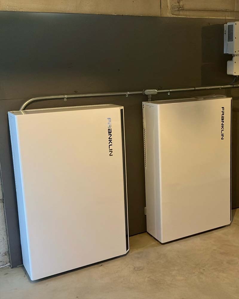 Dual Franklin home batteries mounted on a finished wall as part of a whole-home backup system in Greenfield, MA.