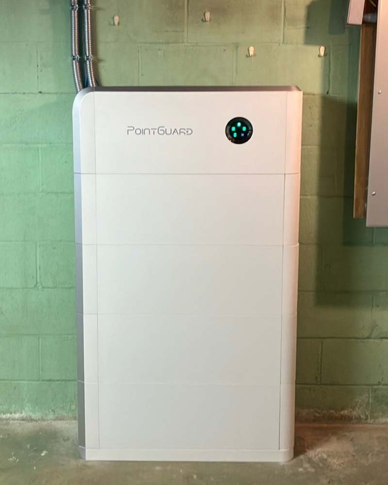 ointGuard home battery mounted against a concrete wall for residential solar energy storage in Greenfield, MA.