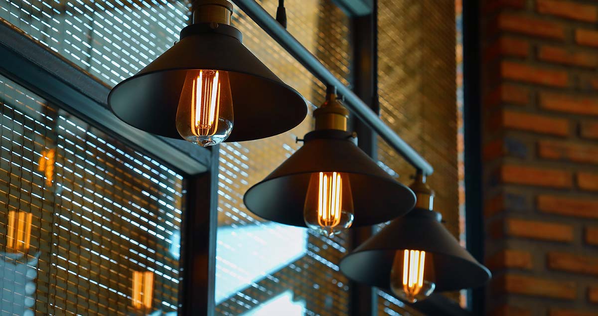 Industrial pendant lighting representing the kinds of commercial interiors Current Energy supports with solar installations in Greenfield, MA.