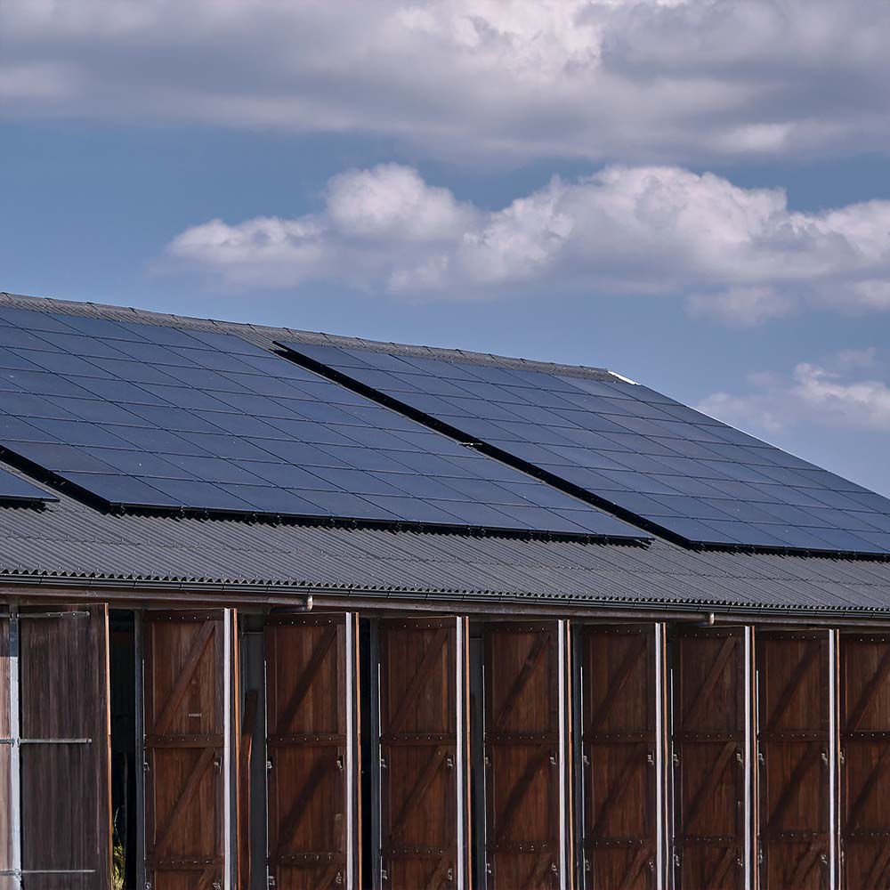 Example of rooftop solar on agricultural storage buildings similar to solar installations Current Energy provides in Greenfield, MA.