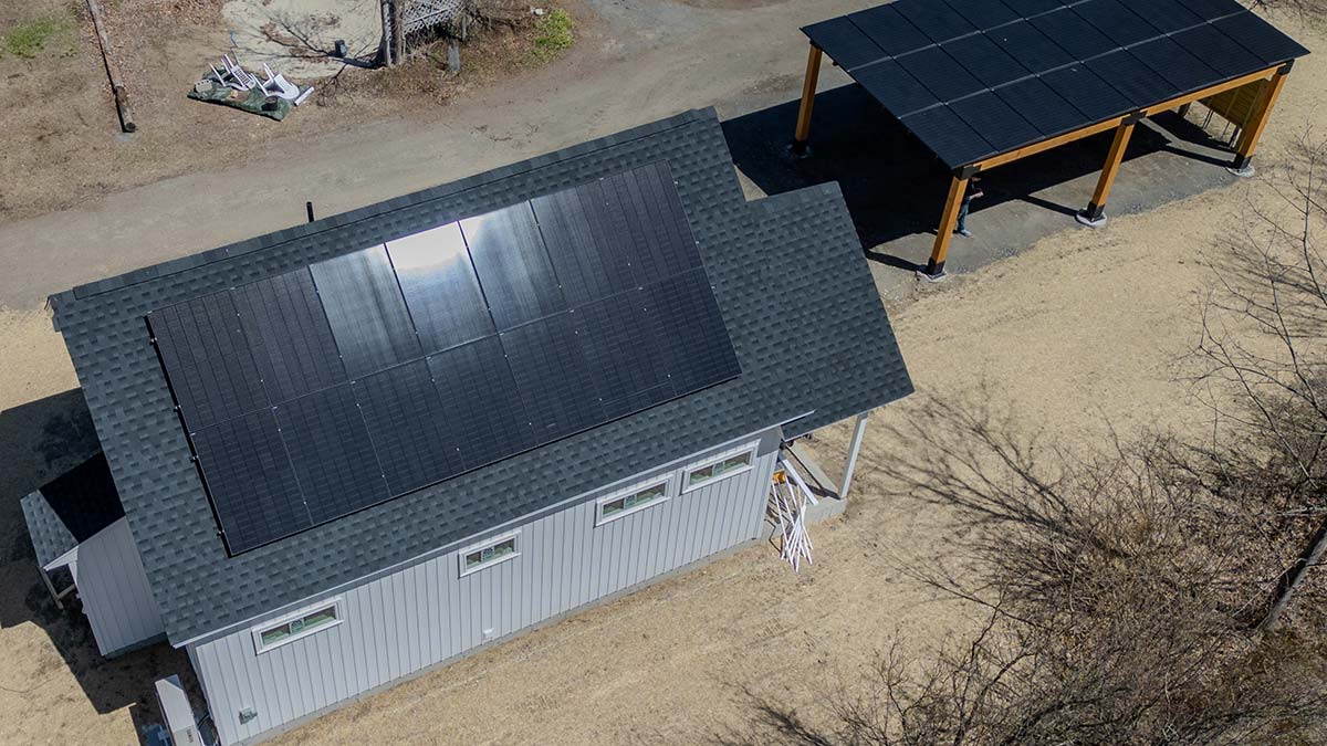 Roof-mount solar panels on a rural home with separate ground-mount solar structure in Franklin County