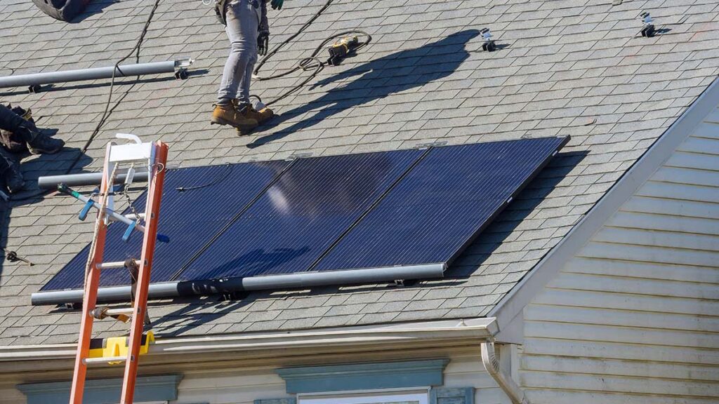 Residential solar installation on a Pioneer Valley home with panels being mounted on an asphalt shingle roof