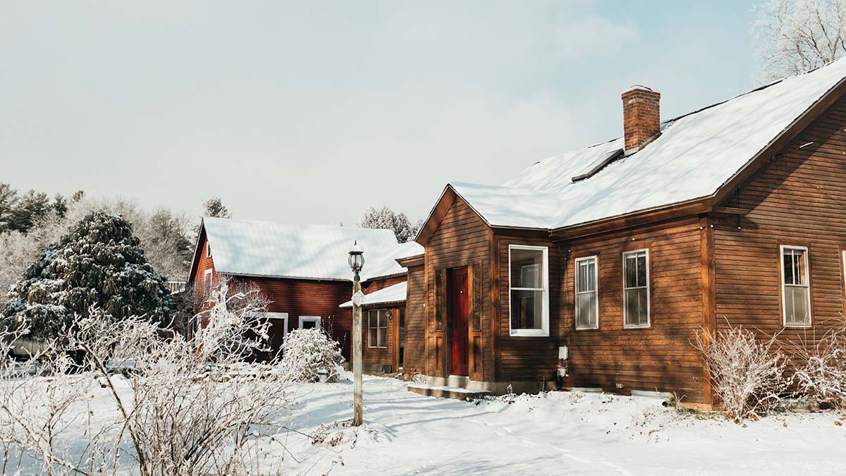 Old New England farmhouse in winter in the Keene area, typical roof and structure considered for residential solar installation