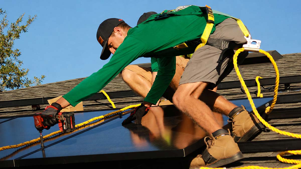 Solar installer securing rooftop solar panels during installation on a residential roof.
Different ways to add solar panels